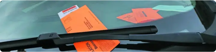 Parking ticket on car windshield